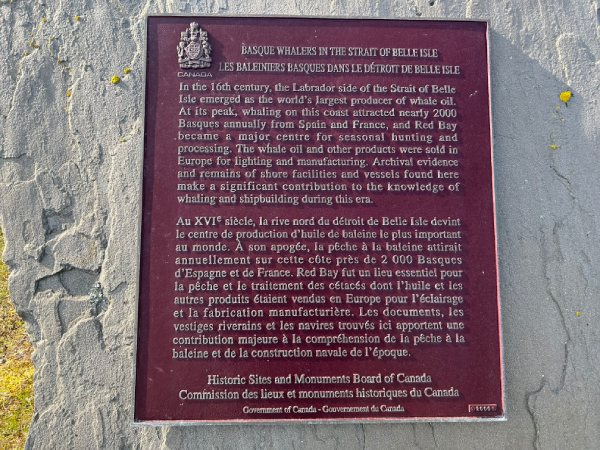 Commemorative plaque installed on a stone with golden text