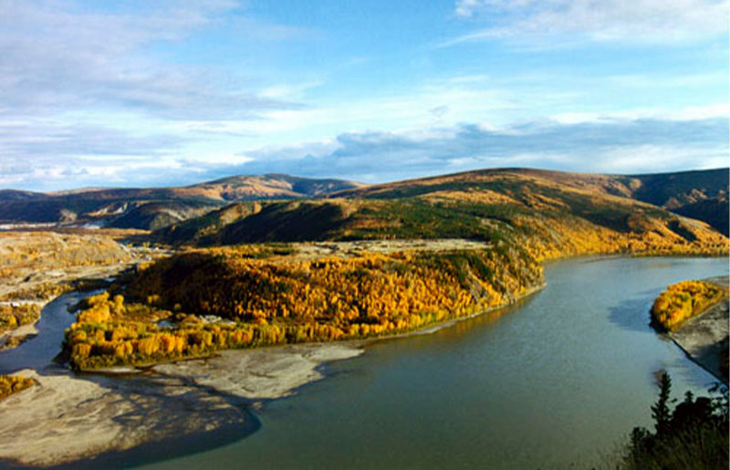 Aerial photo of landscape including the meeting of two rivers and a blue sky