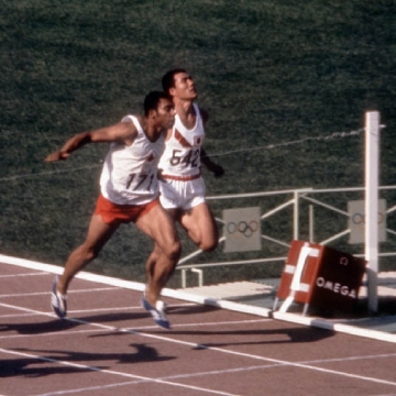 Multiple men during a running race, including Harry Winston Jerome, sprinter in the 1960s