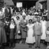 Black and white photo of a group of people outside