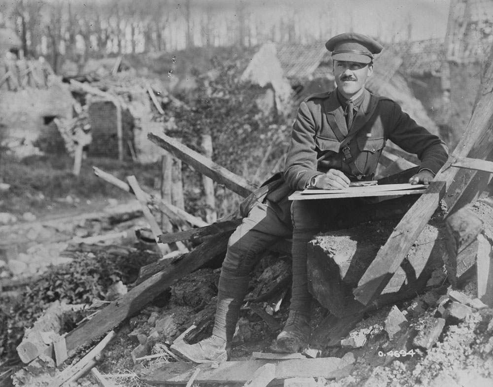 A man sitting outside drawing in a destroyed city 