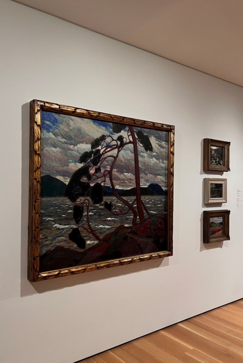 A landscape painting hanging on a gallery wall