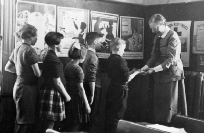 Black and white photo of a group of kids and a woman