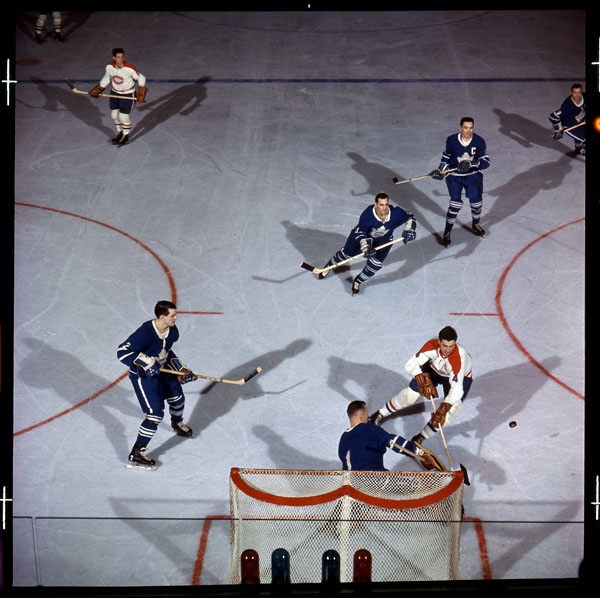 Action shot of two teams playing hockey on ice