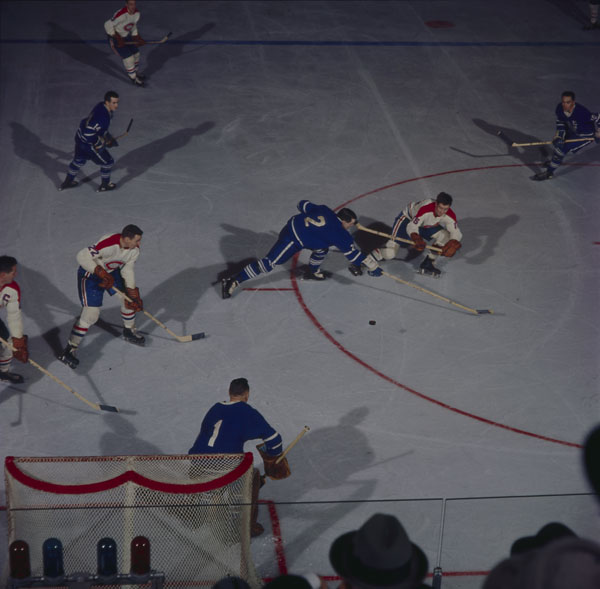 Action shot of two teams playing hockey on ice
