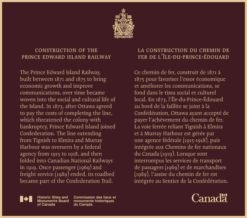 Bronze commemorative plaque with yellow text