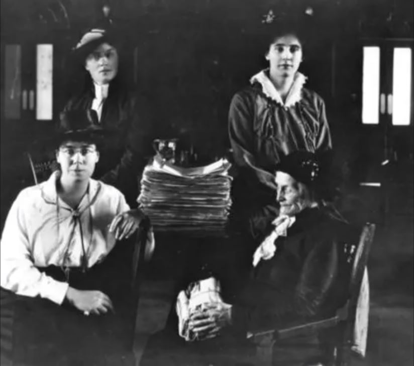A black and white image of four women sitting