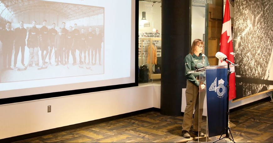 Person doing a presentation in front of a screen