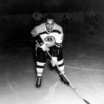 A historic black and white photo of a hockey player