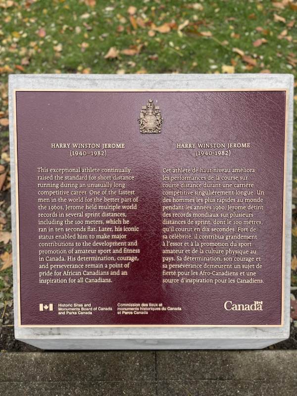 A commemorative plaque installed in an outdoor setting