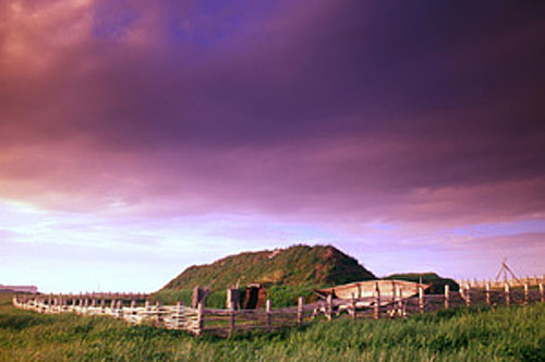 Sunset landscape with wooden fence in a field