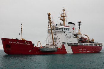 Main search vessel, the Canadian Coast Guard icebreaker Sir Wilfrid Laurier in background with smaller vessel to side.