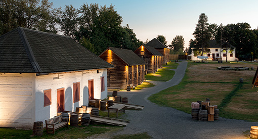 From left: The Storehouse, the Children's Centre, the First Nations Building, the Depot - Full Barrel Cafe, and the Big House at dusk, Fort Langley