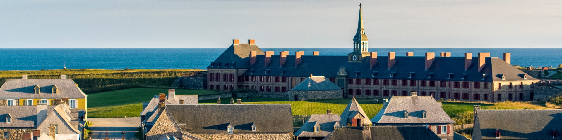 An aerial shot of the Fortress of Louisbourg including the Quay Wall, Frédéric Gate, reconstructed town, and King's Bastion.