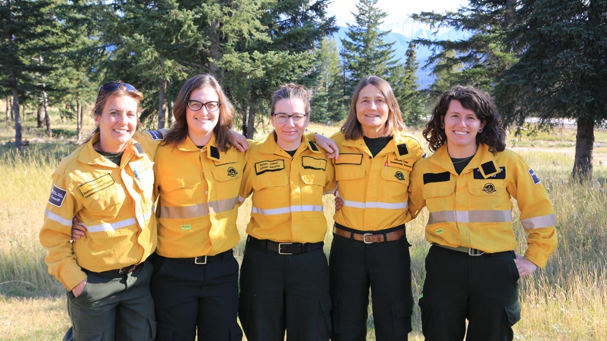 Cinq membres de l’équipe de gestion des incidents posent pour une photo lors du feu de forêt de Chetamon dans le parc national Jasper.