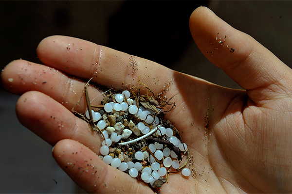 Close-up of plastic pellets held in the hand