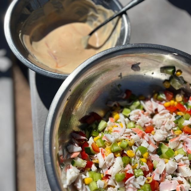 A smaller bowl of sauce placed beside the mixture.