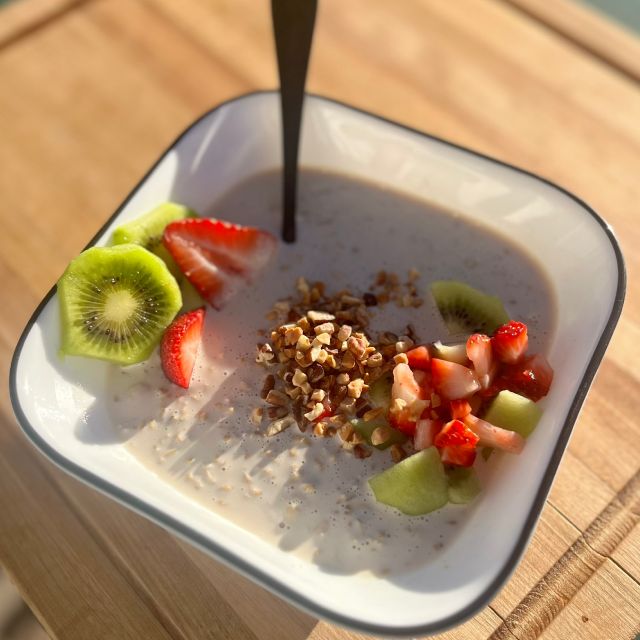A bowl of overnight oats topped with fruit and nuts. 
