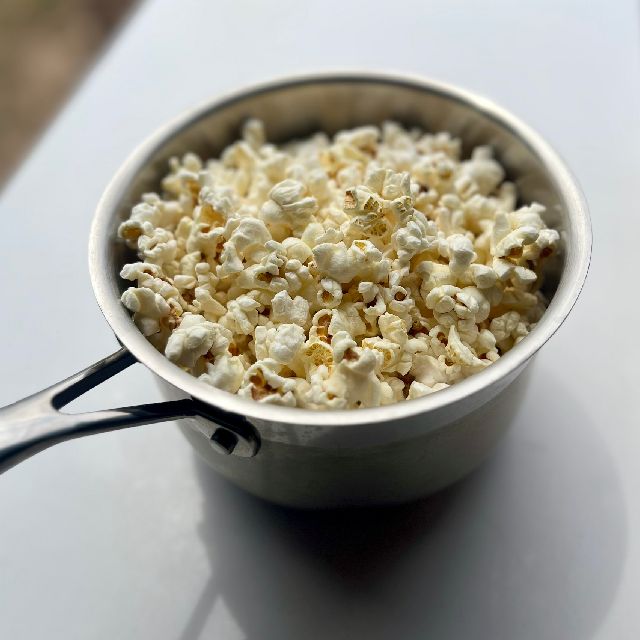  A pot filled with freshly popped popcorn.