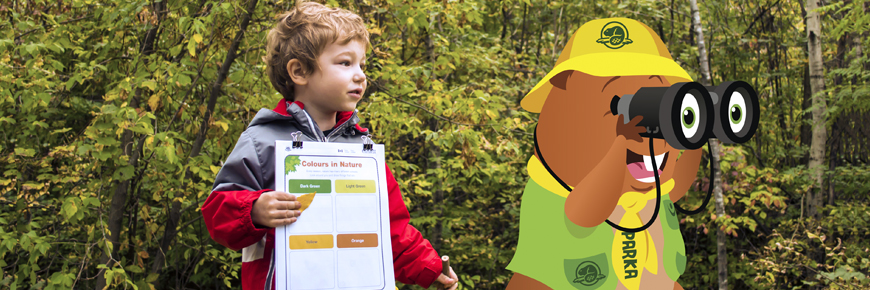 Boy holding a clipboard, an activity sheet and a pencil