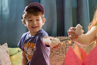 A young boy holding a marshmallow.