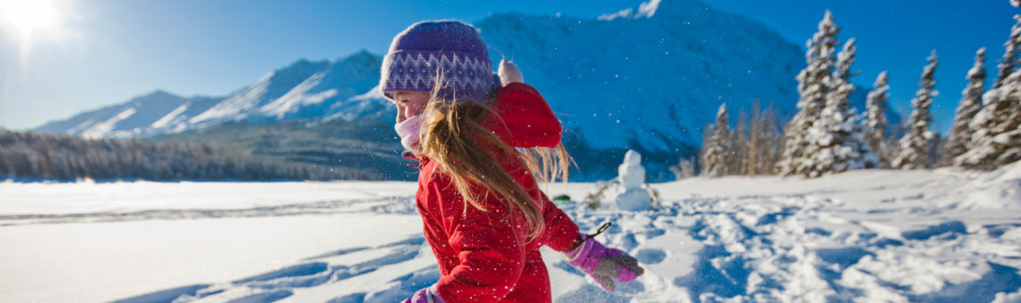 a girl running through the snow