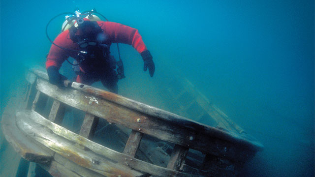 A diver swims over a shipwreck in Fathom Five National Marine Park.