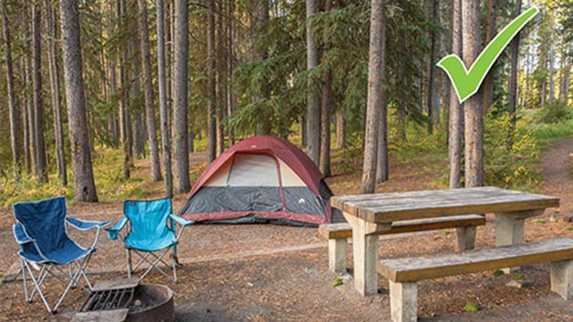 Clean campsite with tent and camping chairs visible. The food related and scented items stored in a hard-sided vehicle or storage locker.