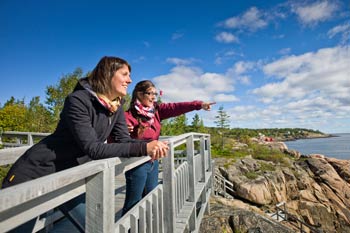 Two visitors on a boardwalk near the Marine Environment Discovery Center.