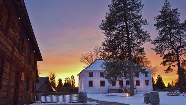 Buildings at the Fort Langley National Historic Site during a winter sunset.