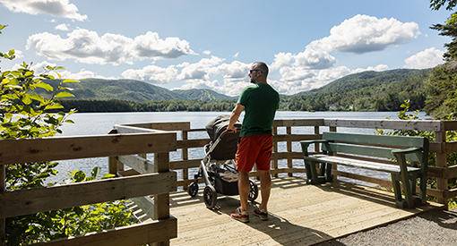 A visitor with a stroller on the Freshwater Lake Trail in Cape Breton Highlands.