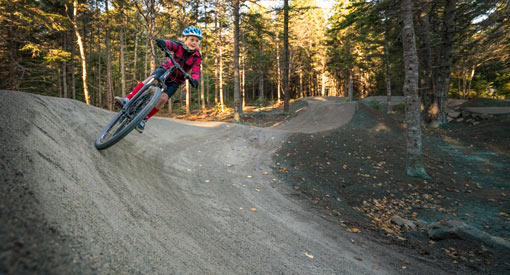A young girl rides her bike at the Pump Track in Chignecto Recreation Area.
