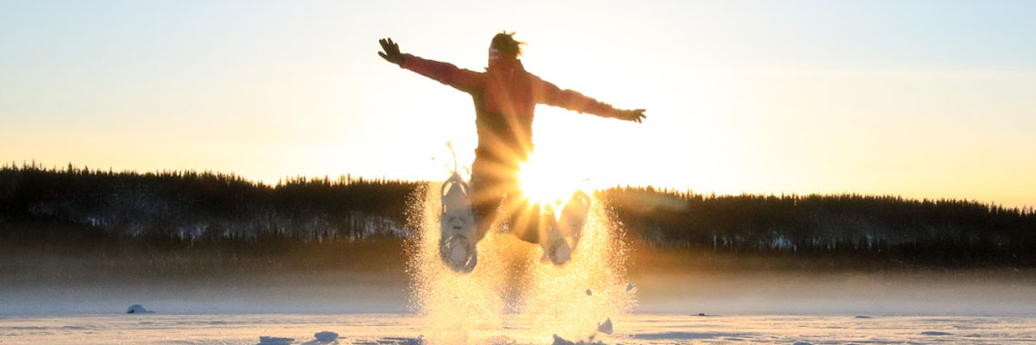 A person with snowshoes on Grosbeak Lake in Wood Buffalo National Park.