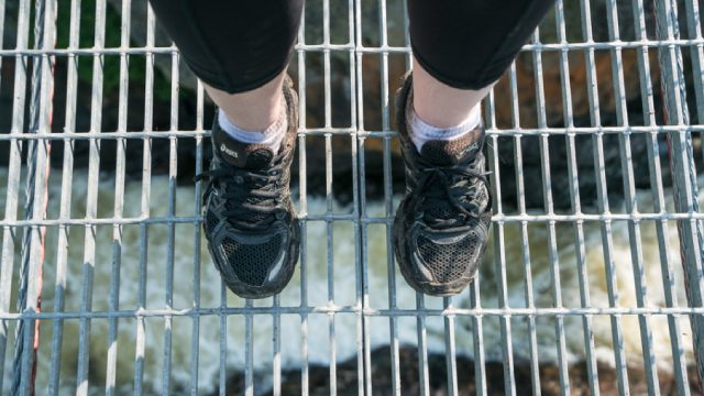  A visitor enjoying a downward view of the White River Suspension bridge high above Chigamiwinigum Falls in Pukaskwa National Park.