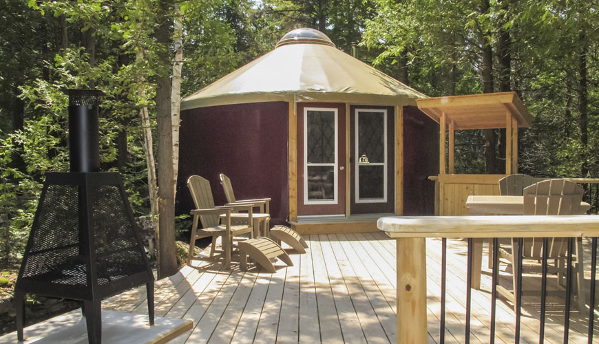 A yurt deck provides plenty of space to relax in deck chairs, cook or keep warm by the fire.