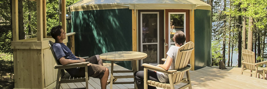 Visitors relax on a yurt patio.
