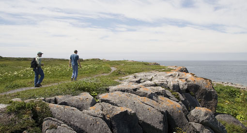 Two visitors by the sea on the Coastal Trail.