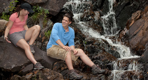 Young couple hiking and being playful at Pissamare Falls.