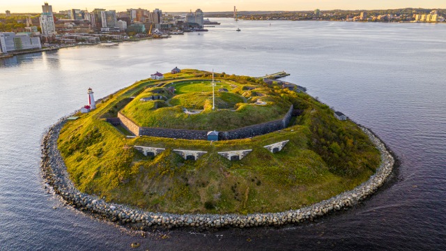 Aerial view of Georges Island National Historic Site with downtown Halifax in the background.
