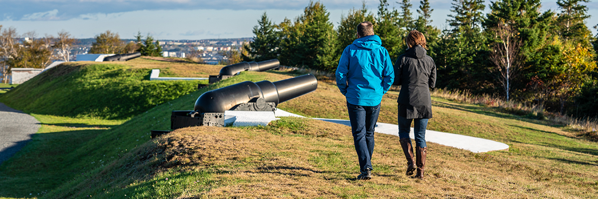 Two people are walking on the grounds of the York Redoubt National Historic Site.