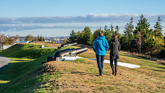 Two people are walking on the grounds of the York Redoubt National Historic Site.