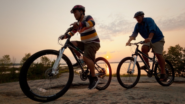 A group of New Canadian have fun with mountain bikes.