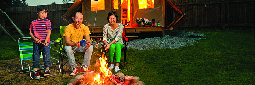 A family enjoys a campfire in front of an oTENTik