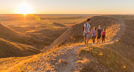 Young adults out hiking on the 70 Mile Butte Trail at West Block, in Grasslands National Park.