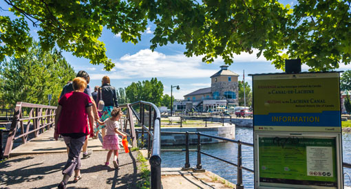 A family walks along the Lachine Canal path.