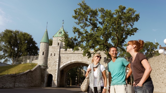 Three visitors at the St-Louis Gates in Old Quebec City.