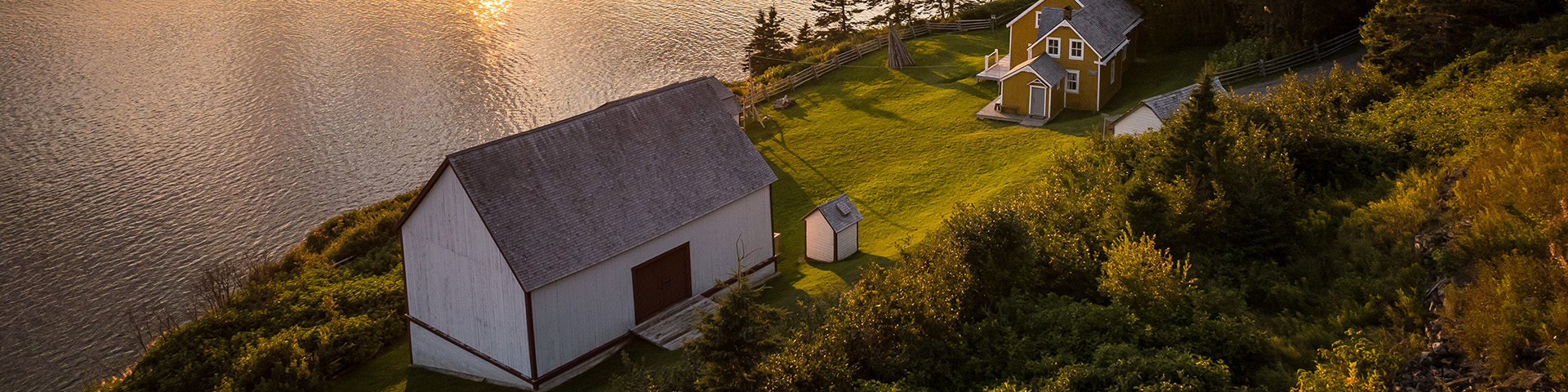 Historic buildings in Grande-Grave, along the shores of Gaspé Bay, at sunset in Forillon National Park.