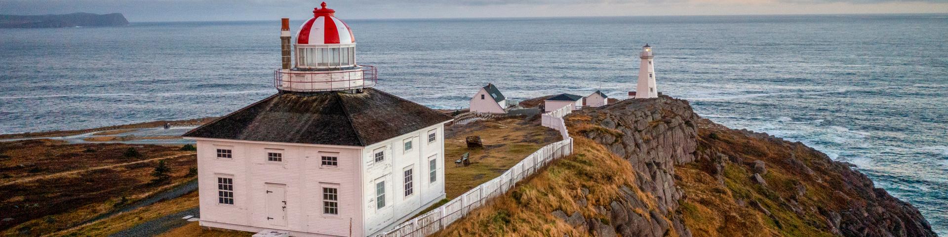 Sunset with historic Cape Spear lighthouse in foreground.