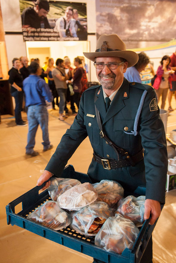 Park warden Terry Willis helps bring food to the guests at the Community Celebration
