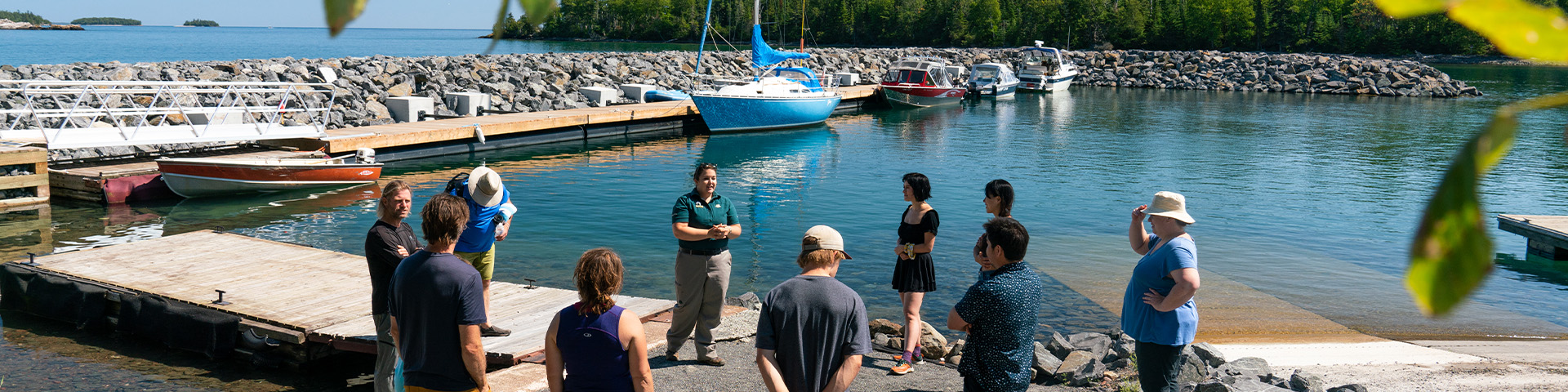 A group listening to a presentation in a marina.